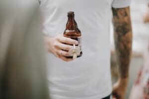 Flasche Bier mit Schnuller, detailreiche Nahaufnahme bei einem Event oder Party.