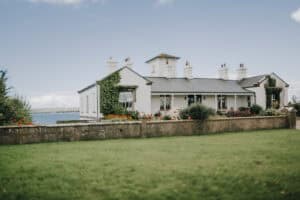 Weißes Haus mit Garten in Irland am Meer. Hochzeitsfotograf Irland könnte hier schöne Fotos machen.