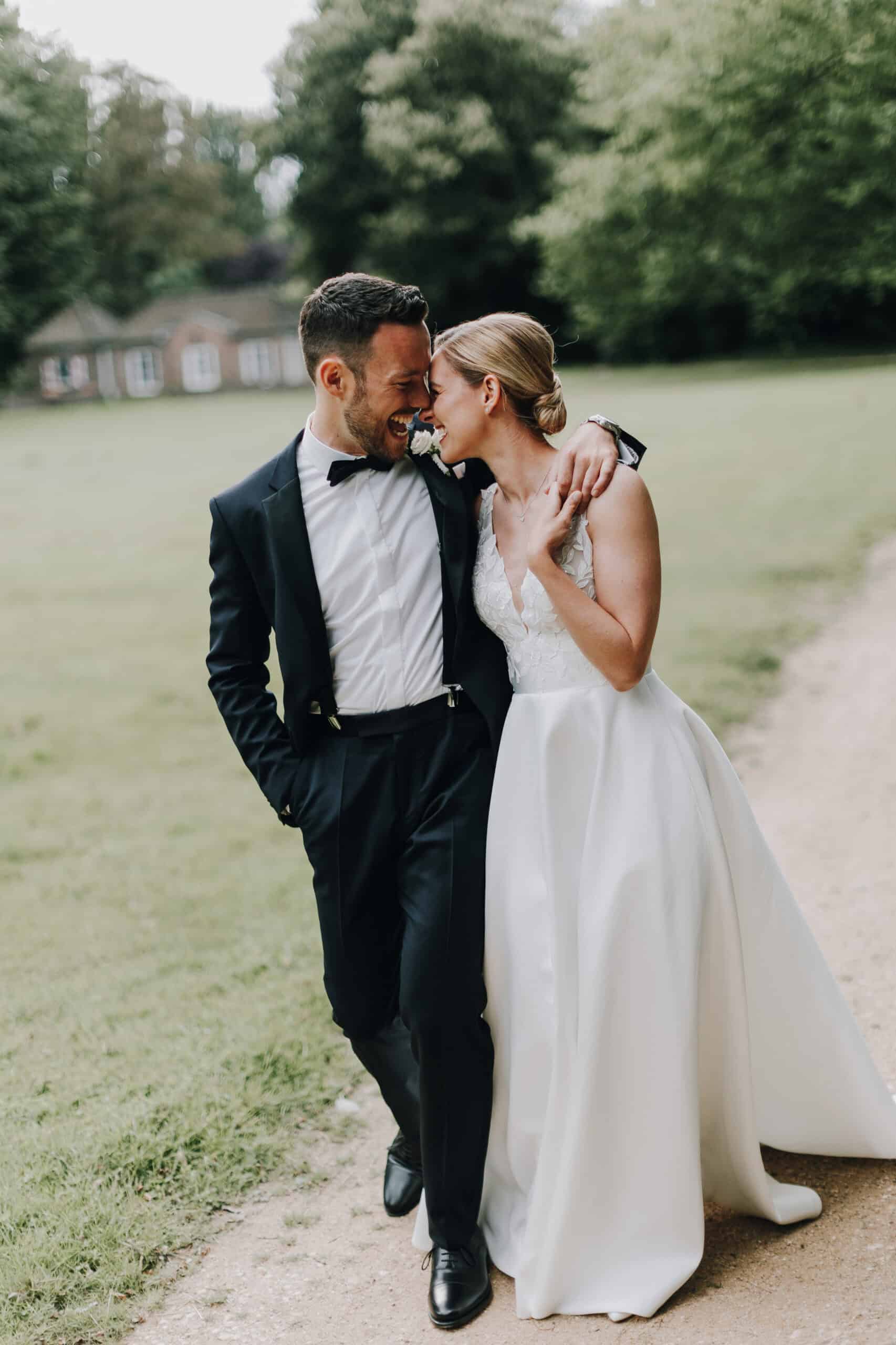 Brautpaar umarmt sich auf einer Wiese. Hochzeitsfotograf Tirol.